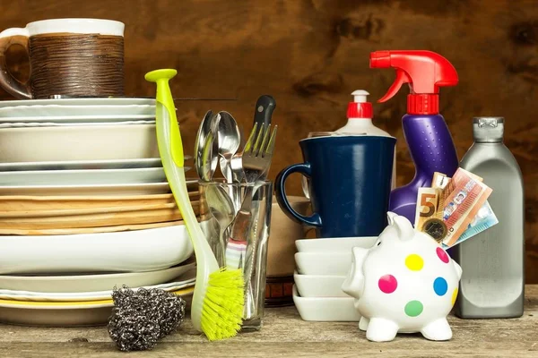 Washing kitchenware. Crockery on a wooden table. Cleaning after home celebration. Housework. — Stock Photo, Image