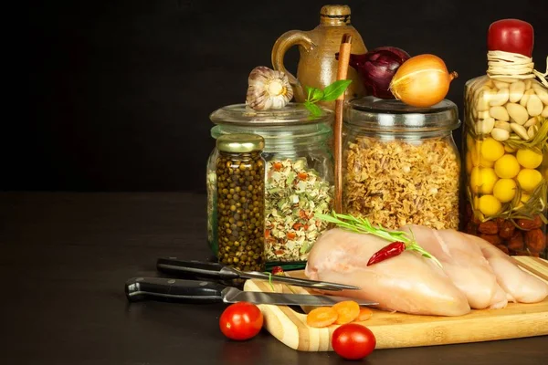 Raw chicken breast on the kitchen board. Diet food. Sale of meat. Spices for preparing meat on grill. — Stock Photo, Image