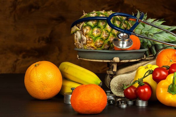 Old cast iron kitchen scale with fruit and vegetables. Healthy eating. Selling fruit.