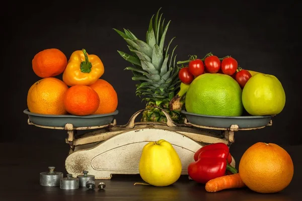 Old cast iron kitchen scale with fruit and vegetables. Healthy eating. Selling fruit.