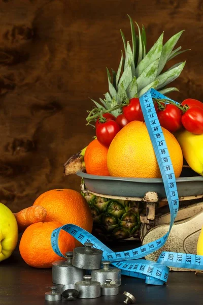 Old cast iron kitchen scale with fruit and vegetables. Healthy eating. Selling fruit.