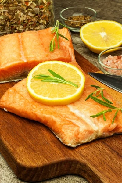 Frozen salmon on the kitchen table. Diet food. Home cooking fish.