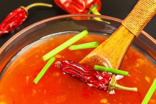 Sos biber ile yaptı. Baharatlı gıda hazırlanması. Sağlıklı gıda. Siyah bir arka plan üzerinde.