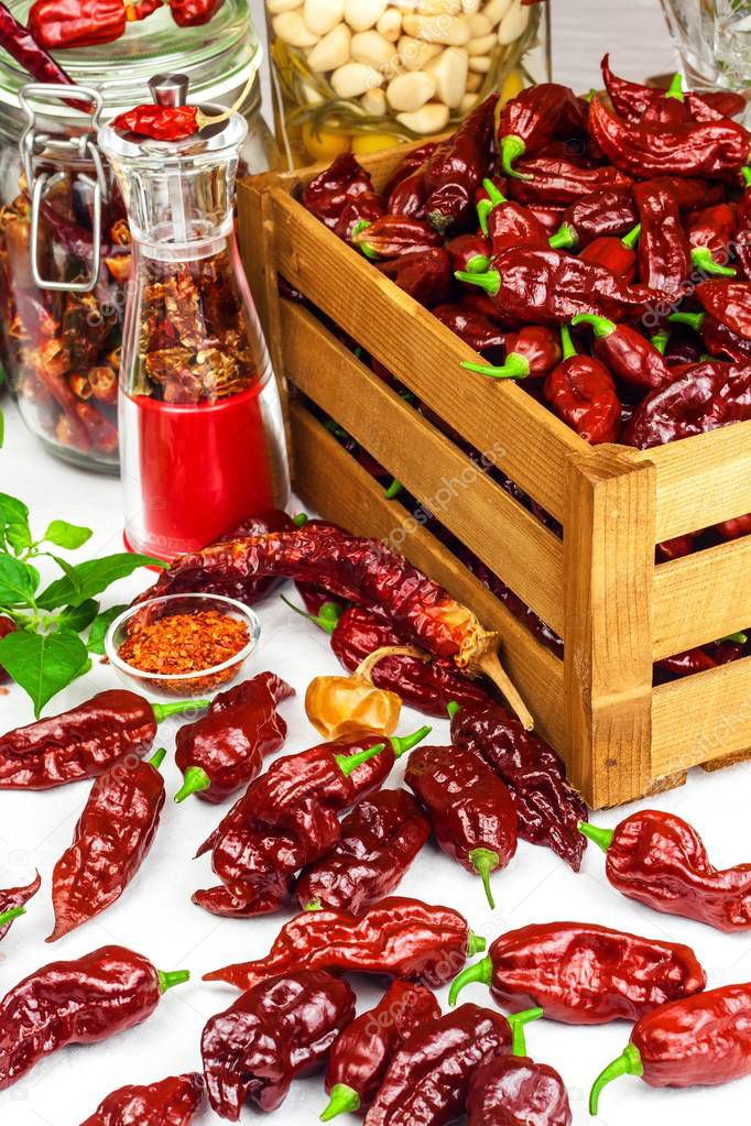 Harvest or chilli. Chili (Bhut Jolokia Chocolate) in a wooden crate. Preparation for drying. Spicy food. Sale of spices.