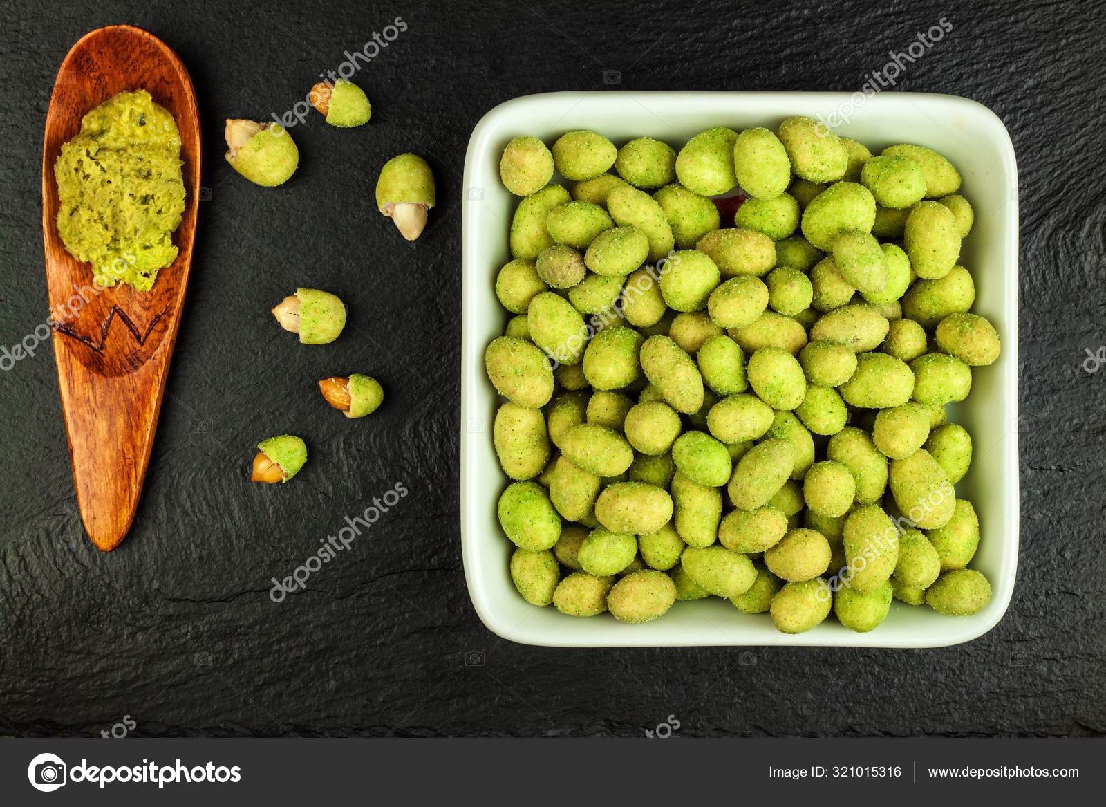 Wasabi Coated Peanuts on slate board. Japanese Wasabi Spice. Green