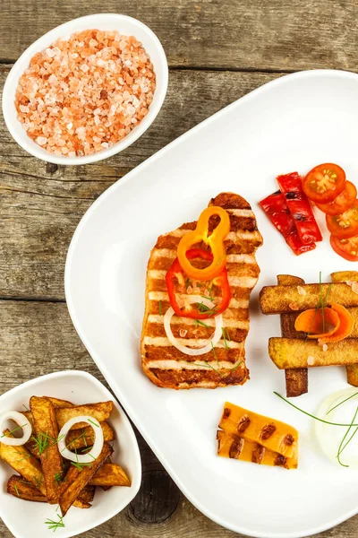 Grilled pork chop with french fries on white plate. Homemade barbecue. Healthy food. — Stock Photo, Image