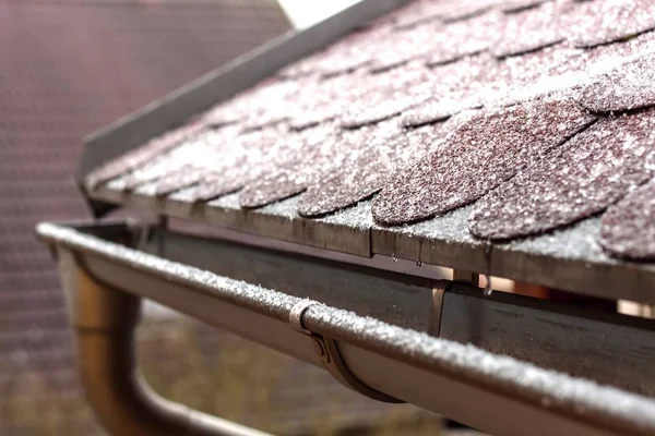 Frost on the roof of the terrace. Ice roof coating. Cold weather. Ice crystals on the roof covering.