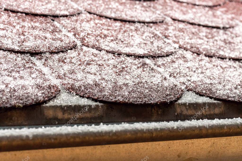 Frost on the roof of the terrace. Ice roof coating. Cold weather. Ice crystals on the roof covering.