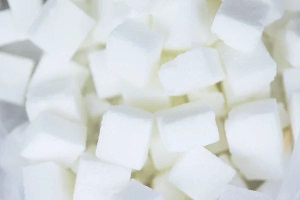 Close up of white sugar, top view / Sugar cubes texture backgro — стоковое фото