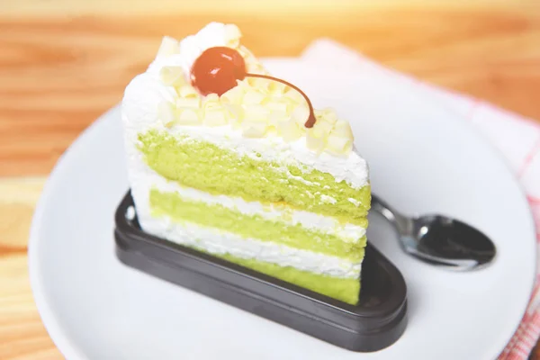 Delicious green tea cheese cake - Green cake slice with cherry f