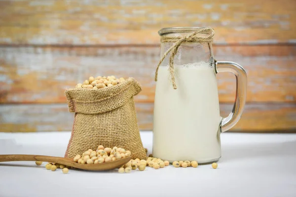 Soybean and dried soy beans on white bowl - Soy milk in glass ja