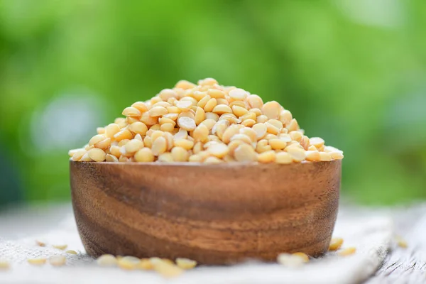 Soybean in a wooden bowl with nature green background - Peeled S — Stock Photo, Image