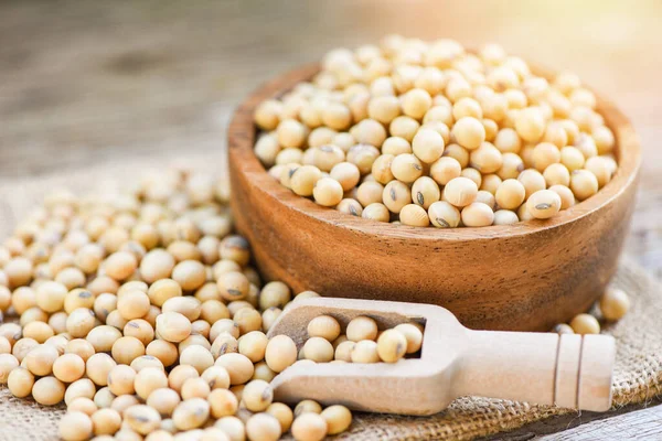 Soybean in a wooden bowl agricultural products on the sack backg — Stock Photo, Image