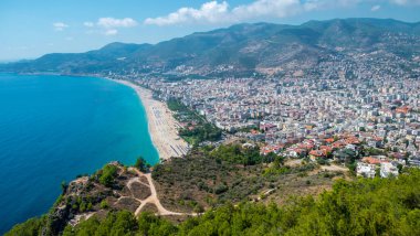Alanya plajı, dağın tepesi, kıyıları mavi deniz ve...