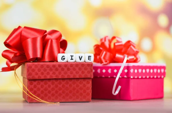 Give gift concept - Giving a gift box present wrapped with red r — Stock Photo, Image