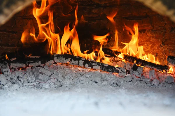 fireplace with log wood burning clay stove fire in home in the w