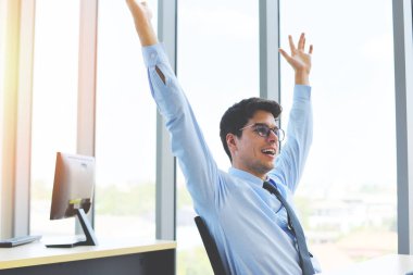 Celebrating success businessman win in his business startup in a office / Business man happy completed job and Successful deal 