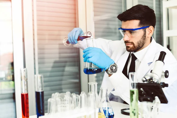 Male Scientists or doctor in lab biochemistry genetics forensics microbiology and test tube / Scientist research working together conduct experiments in modern laboratory