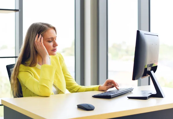 Business woman suffering stress working computer on the desk / Stressed woman tired with headache at office feeling sick at work concept