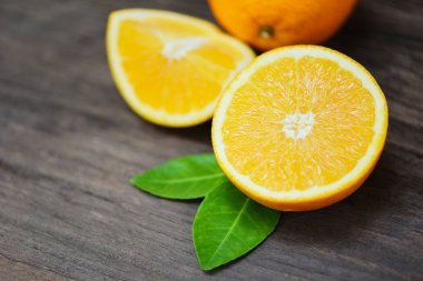 Orange fruit on wooden background / Fresh orange slice half and orange leaf healthy fruits harvest concept