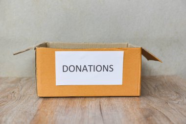 Tahta masa arkasındaki bağış kutusu / bağış konsepti