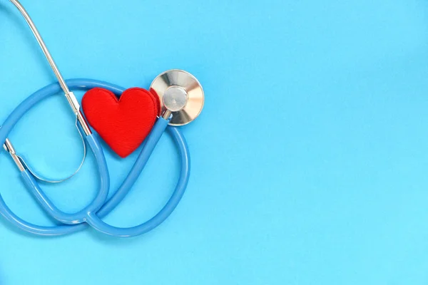 Heart health and red heart with stethoscope on blue background / world heart day world health day or world hypertension day and health insurance concept