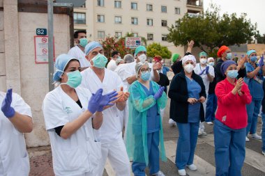 Malaga, İspanya. 11 Nisan 2020. Mlaga 'lı Carlos Haya hastanesinin sağlık personeline polis, sivil ve itfaiye teşkilatından Covid-19 haraçları..