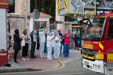 Malaga, İspanya. 11 Nisan 2020. Mlaga 'lı Carlos Haya hastanesinin sağlık personeline polis, sivil ve itfaiye teşkilatından Covid-19 haraçları..