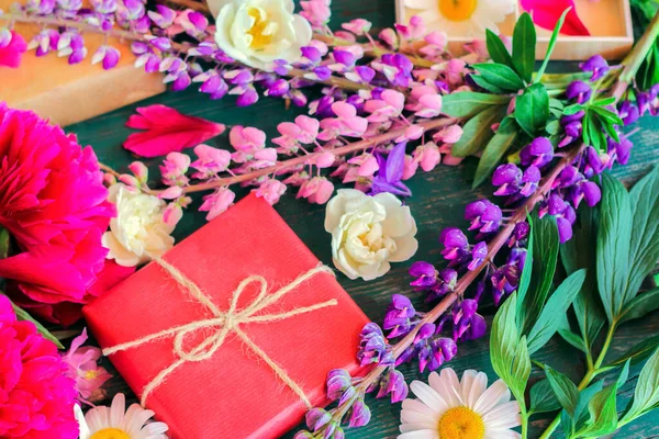 summer multicolored peonies, daisies, lupins. Preparing a romantic surprise and wrapping gifts. summer mood, Summertime season