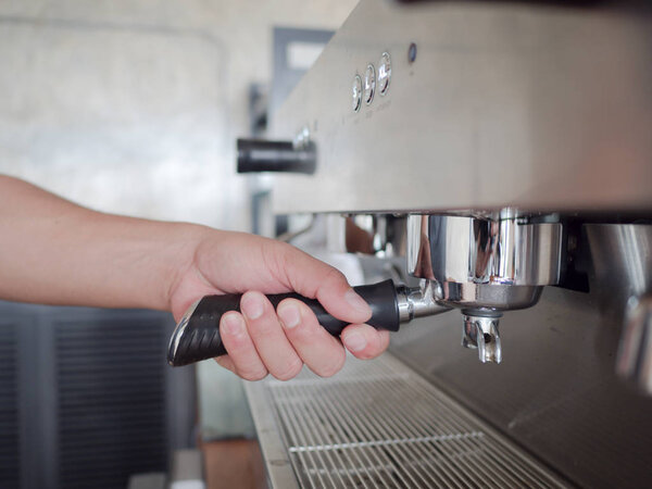 hand making coffee in a coffee shop.