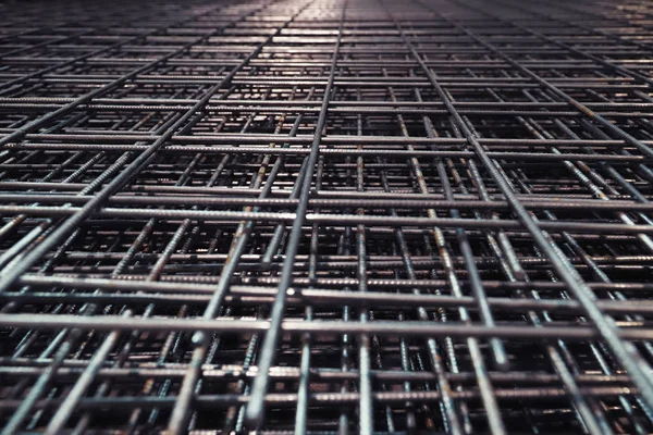 Steel bar for building materials. Wire reinforcing mesh. Industrial grunge background.