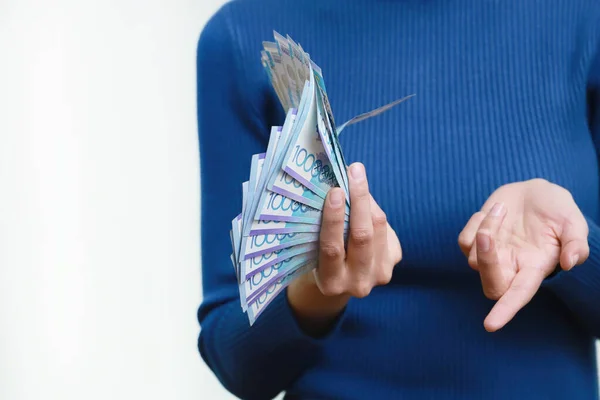 Bir kadın elinde bir sürü Kazakistan parası yatıyor. Beyaz arkaplan. — Stok fotoğraf