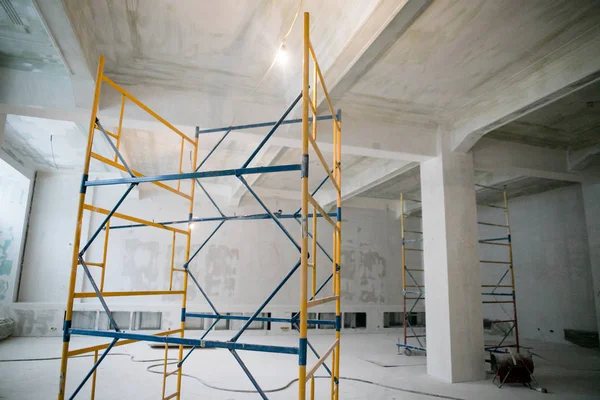 Interior construction of warehouse concrete wall and scaffolding.