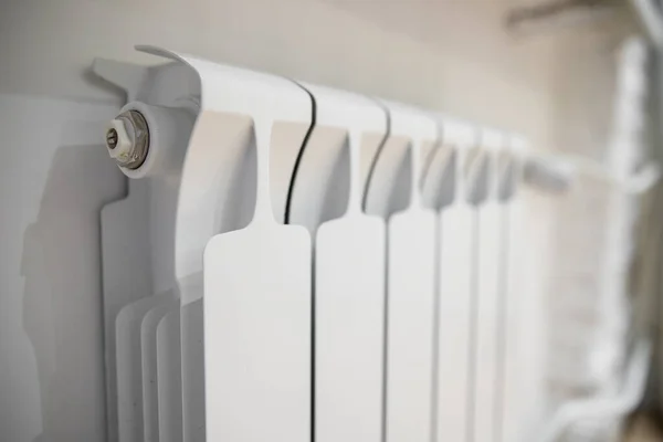 White heating radiator heat the room. Heating Radiator, White radiator in an apartment.