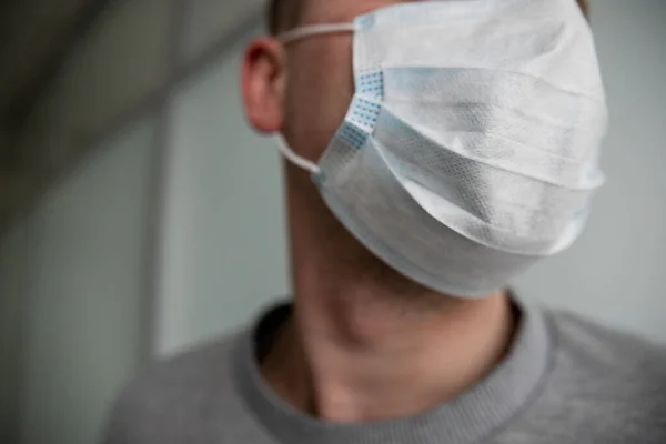 medical mask on a mans face closeup