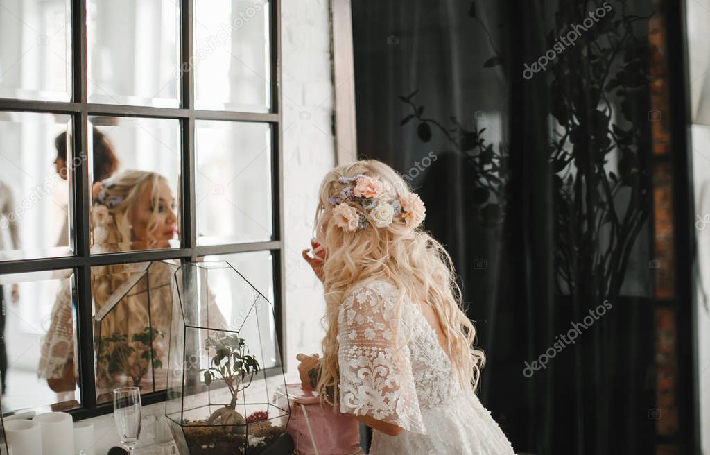 tender blonde bride posing on a wedding morning