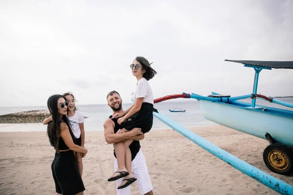 happy asian family hugging and having fun but relaxing holiday on Bali island in Indonesia