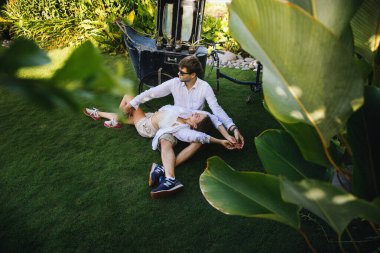 Birbirine aşık çiftler, Endonezya 'nın Bali adasında, palmiye ağaçlarının yanında romantik bir yürüyüşe çıkıp eğleniyorlar.