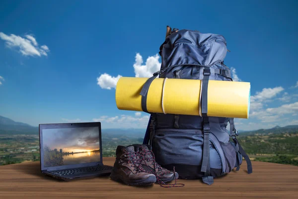 Backpack, trekking shoes, notebook, traveler equipment