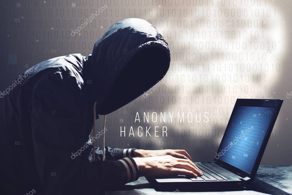 Hacker with laptop initiating cyber attack