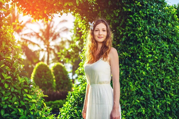 Yeşil çalılar şekli kalp gibi arka plan üzerinde duran kadın — Stok fotoğraf