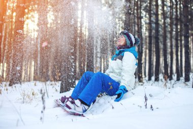 Kadın Snowboard snowboard ile kar üzerinde oturmuş dinleniyor