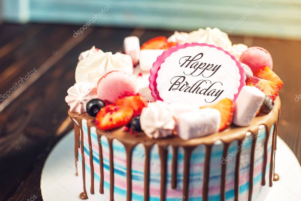 beautiful dessert cake with strawberries and marshmallows on wooden background