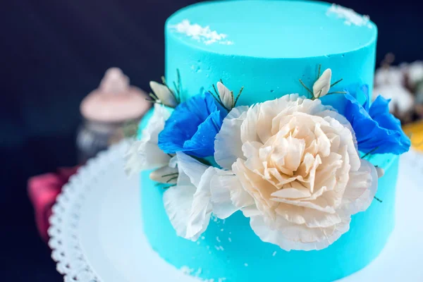 Blue like ice a wedding cake decorated with large roses