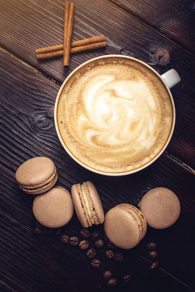 Flavored coffee cappuccino with macarons and cinnamon. The perfect Breakfast — Stock Photo, Image