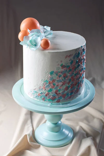 Wedding cake pastel style with blue flowers and orange balls — Stock Photo, Image