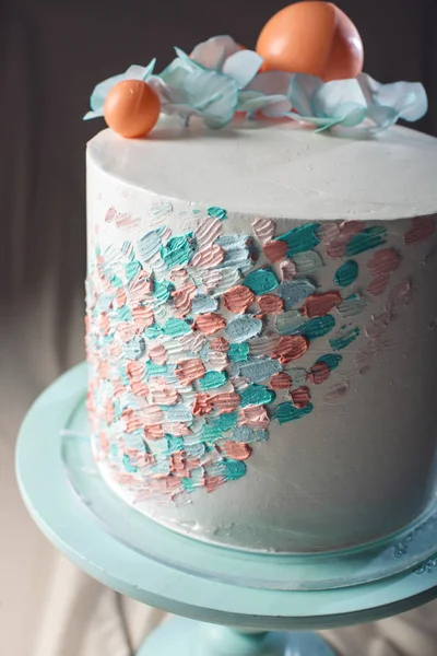 Wedding cake pastel style with blue flowers and orange balls — Stock Photo, Image