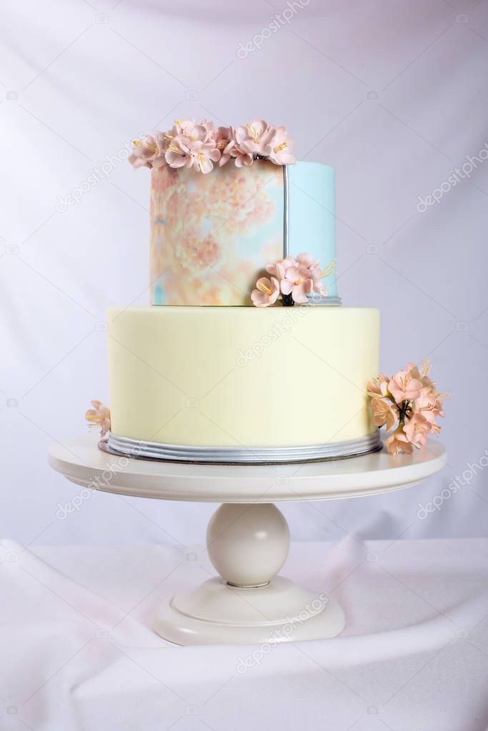 Artwork. Wedding cake decorated in pastel style with pink flowers