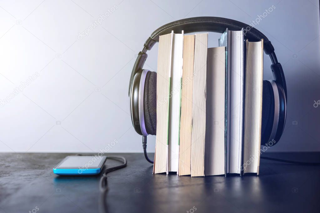 Headphones on books. The concept of audiobooks