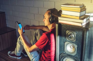 Kulaklık Ses Kaseti dinlerken çekici bir genç adam. Teknoloji eğitimi olumlu bir yaşam tarzı kavramı